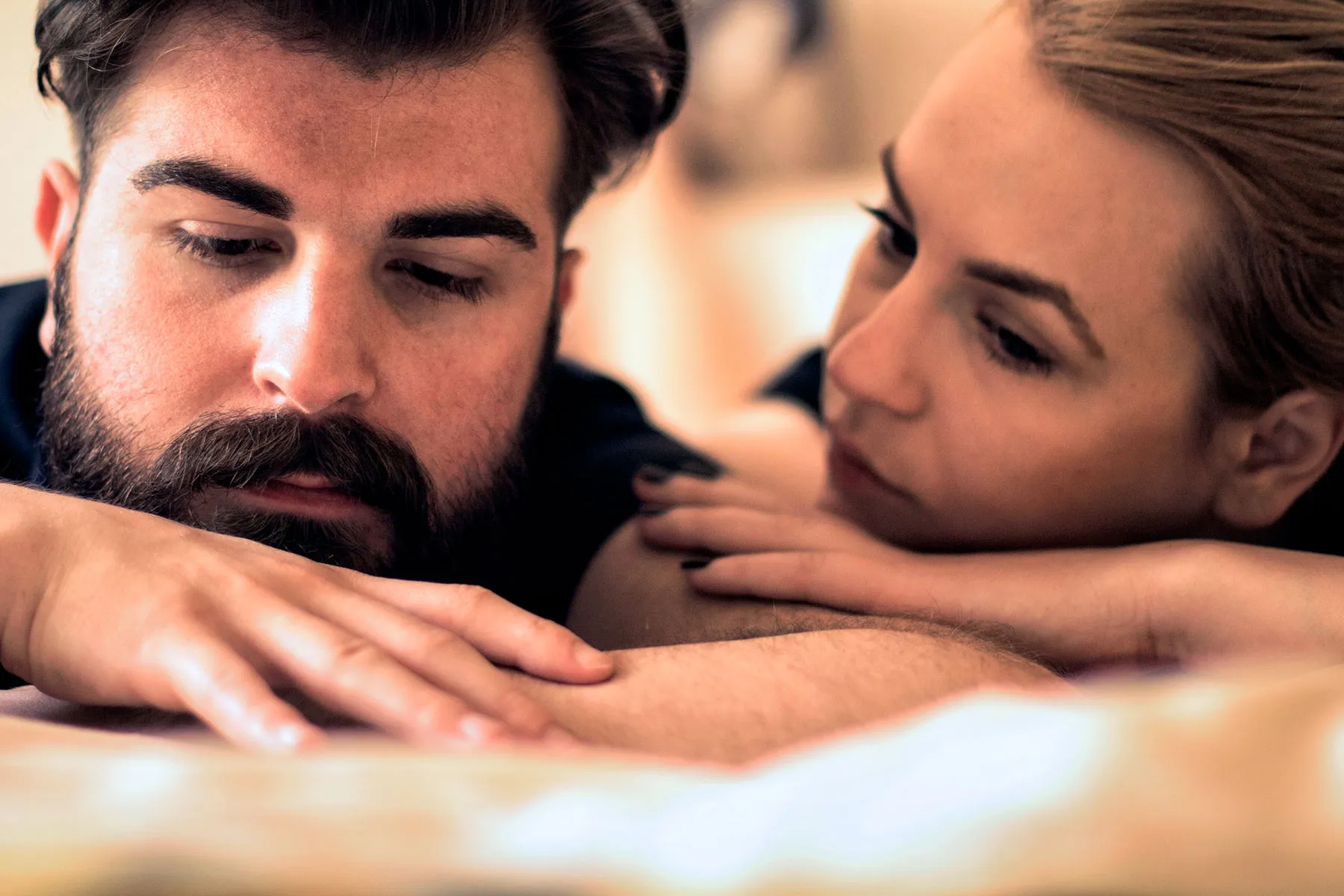 photo of Unhappy young couple in bedroom