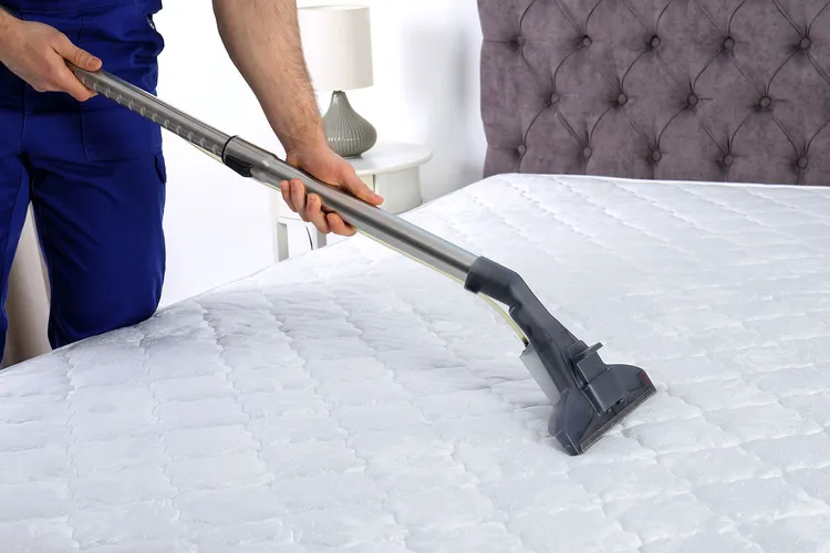 photo of Man disinfecting mattress
