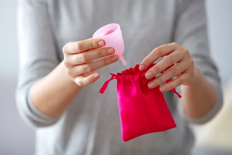 photo of woman holding menstrual cup