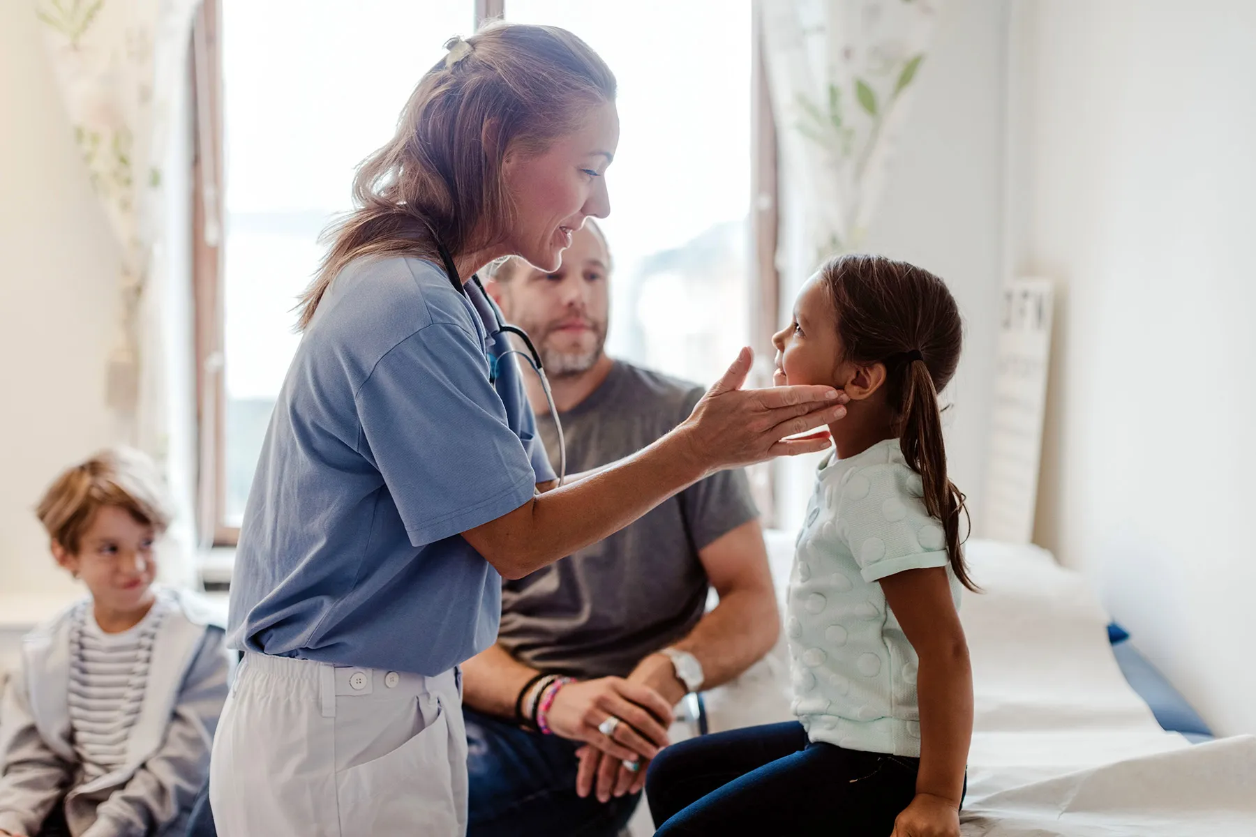 photo of nurse examining girl's throat