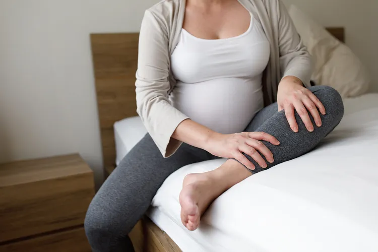 photo of pregnant woman with leg cramp