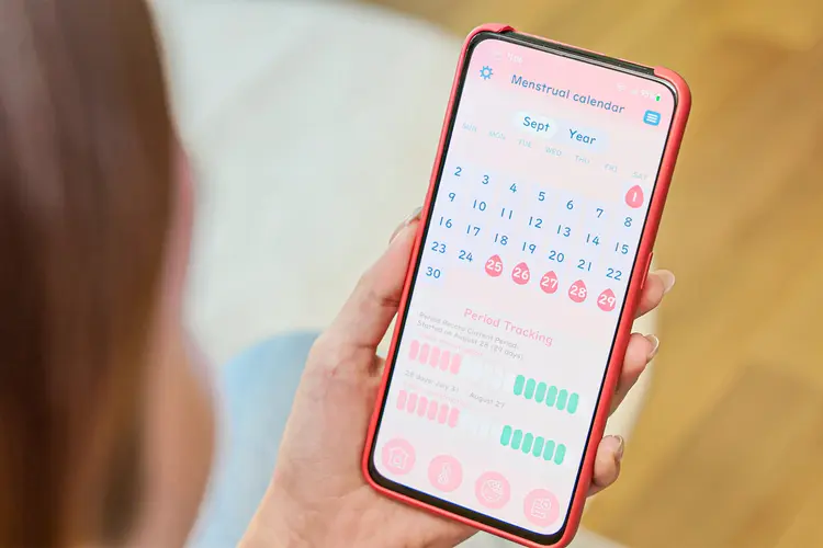 photo of woman using menstrual tracking app
