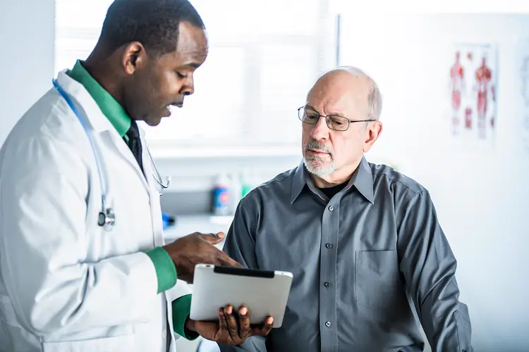 photo of doctor talking to patient