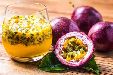 You can eat the pulp and seeds of passion fruit directly from the cut fruit, or use them in foods and drinks. (Photo Credit: iStock/Getty Images)