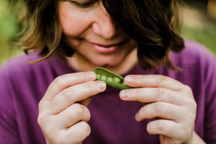 photo of Woman eating organic peas