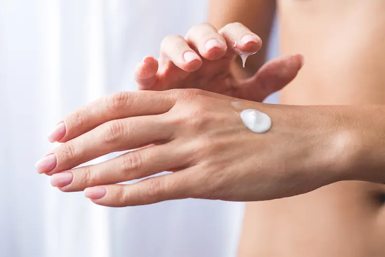 photo of Woman applying moisturizing