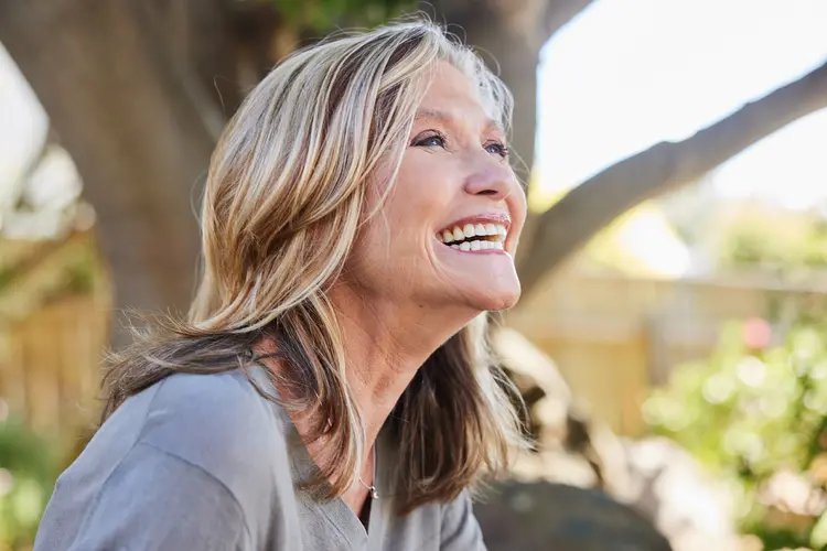 photo of older woman laughing outdoors