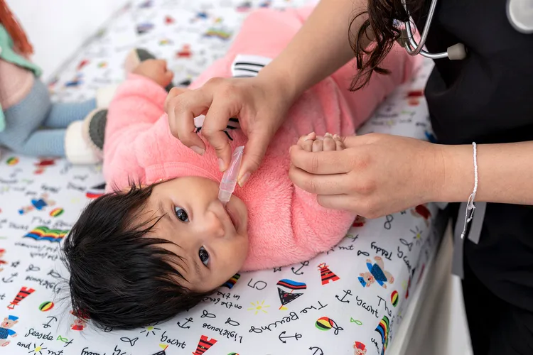 photo of baby receiving oral vaccination