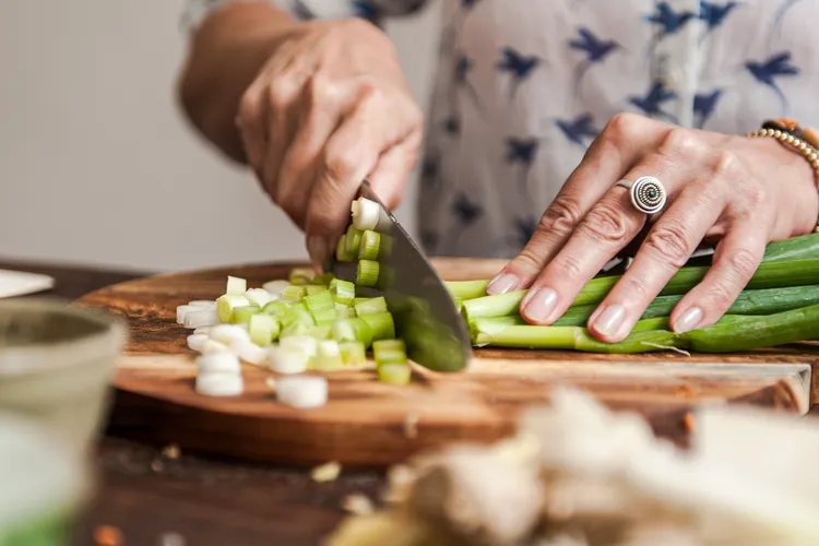 photo of Woman chopping scallions 