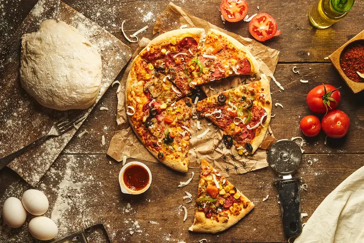 photo of  pizza dough with plenty of ingredients