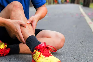 Repeated stress from exercise such as running without supportive shoes can cause painful shin splints. You may feel it along or on either side of your shin bone or tibia. (Photo credit: iStock/Getty Images)