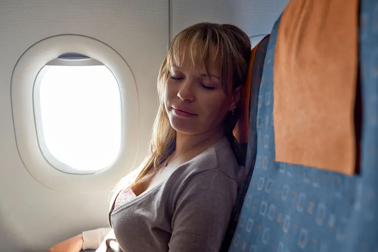 photo of Relaxed woman sleeping on plane