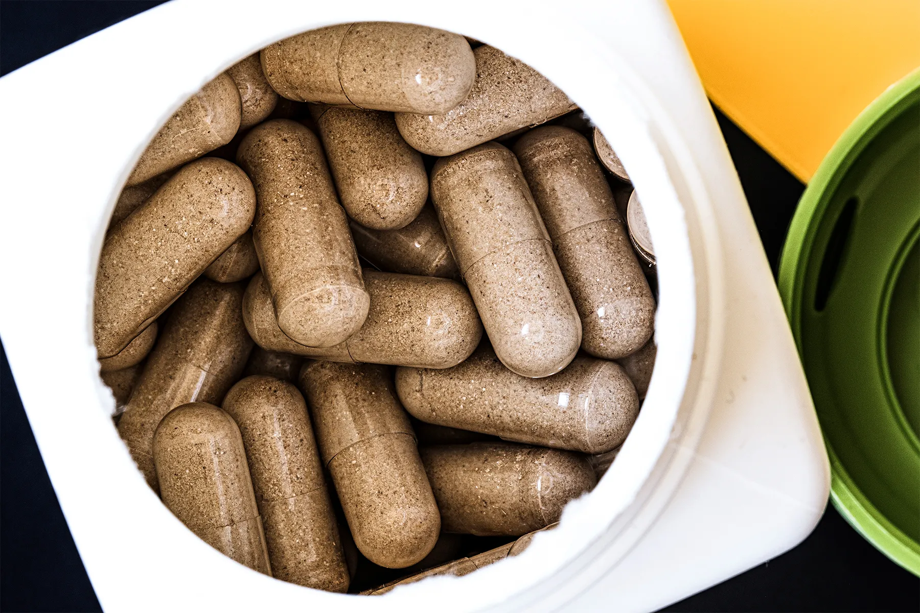 container of brown slippery elm capsules