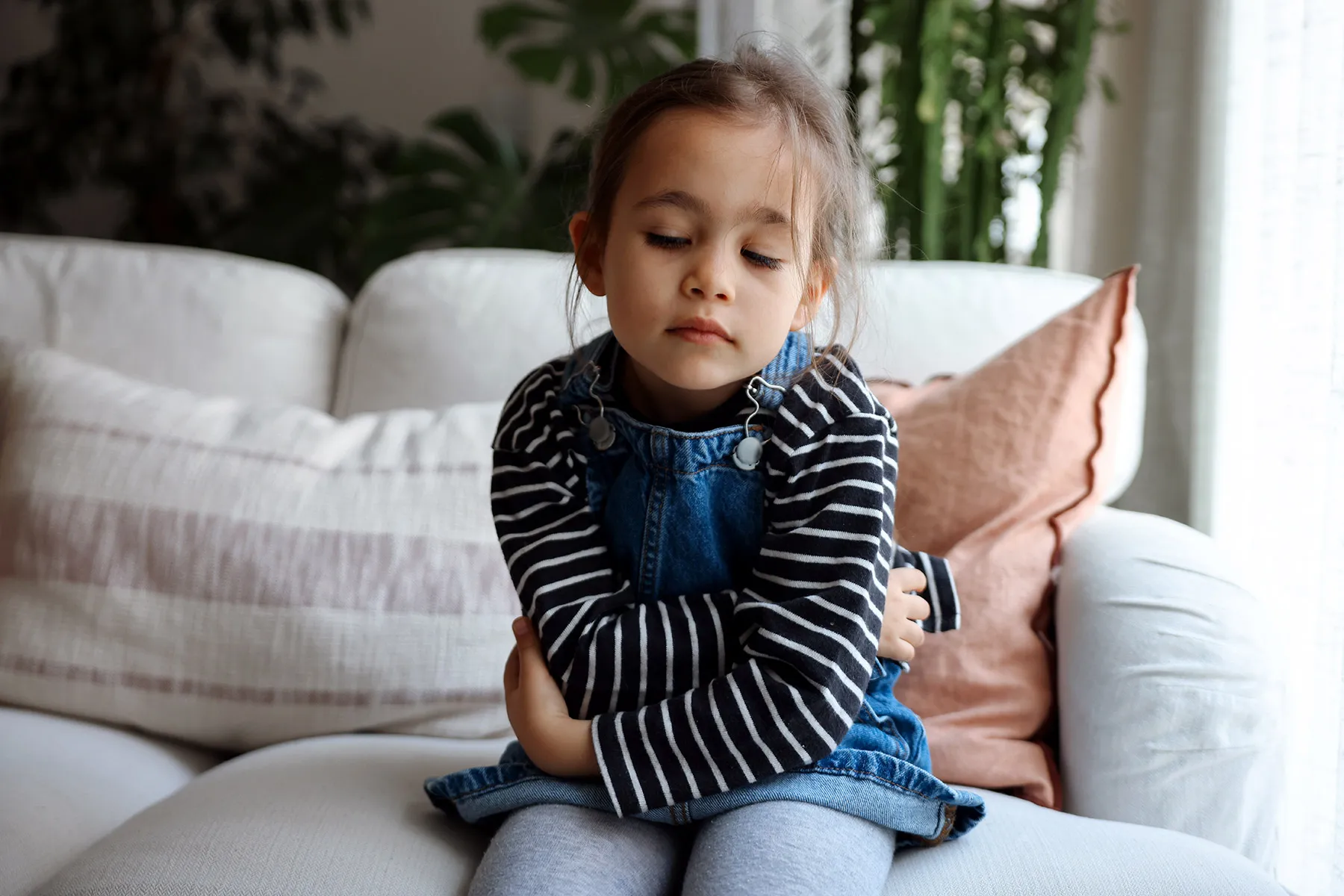 photo of young girl with stomach pain