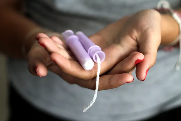 photo of woman holding tampon