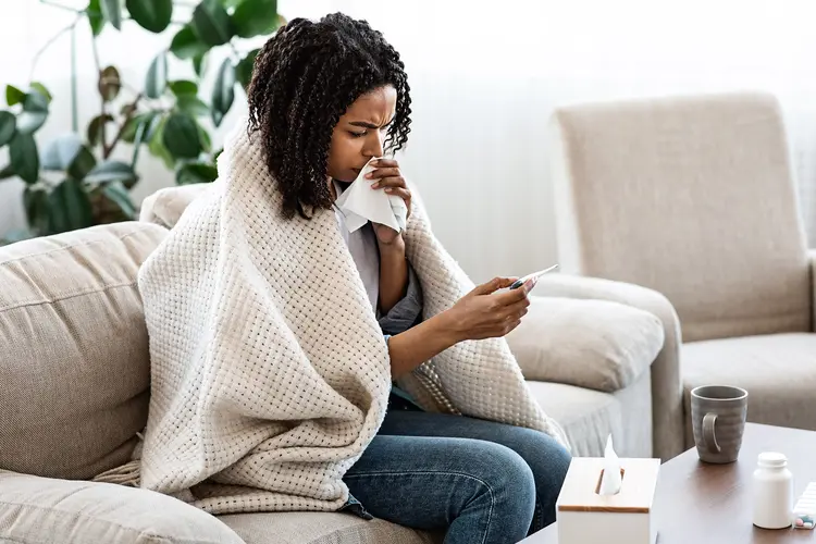 photo of young woman reading digital thermometer