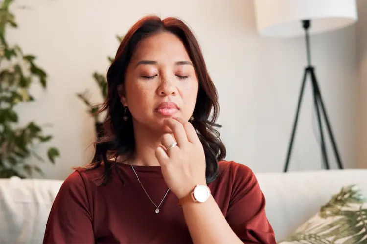 photo of woman applying EFT tapping to chin