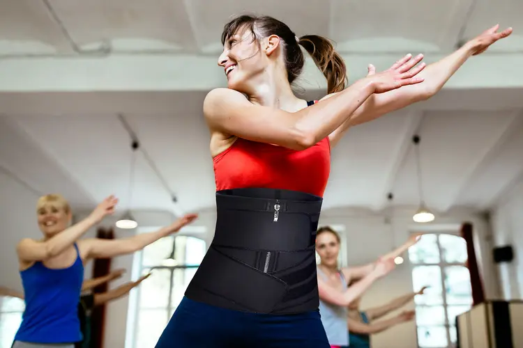 photo of woman exercising while wearing waist trainer