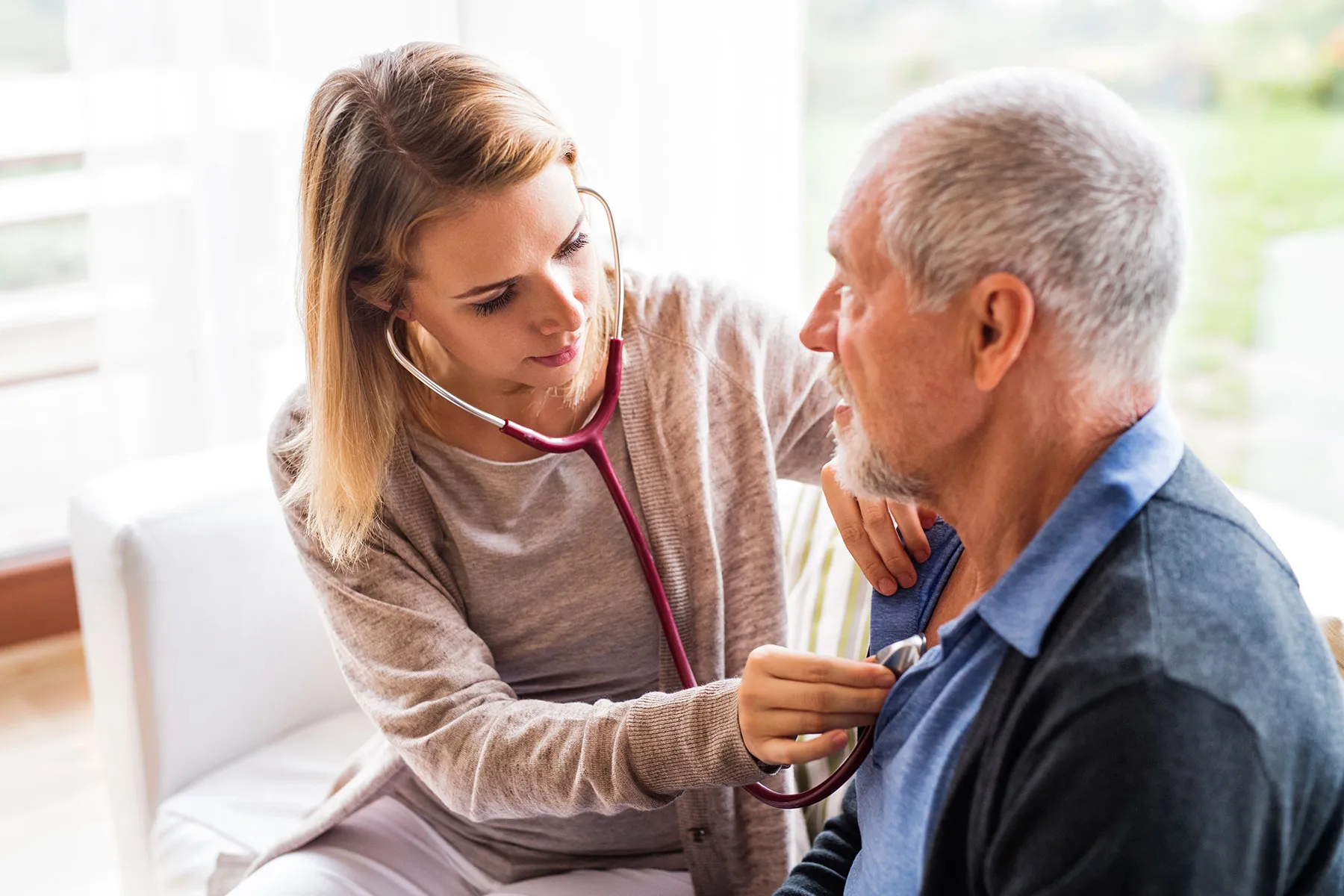 photo of nurse checking heart of senior patient