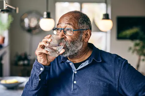 photo of  senior man drinking water 