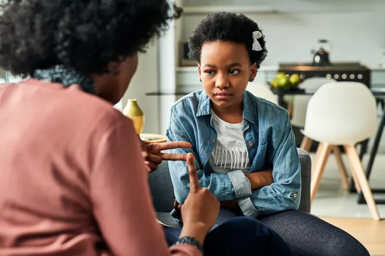 photo of mother disciplining young daughter