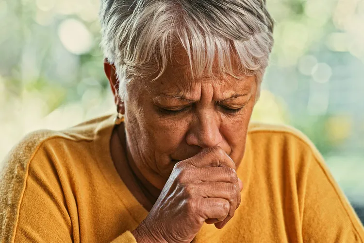photo of senior woman coughing