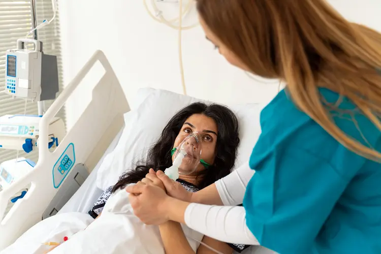 photo of woman lying in hospital bed