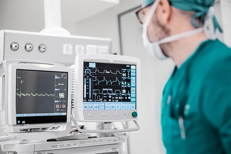 photo of Male surgeon looking at the monitoring equipment