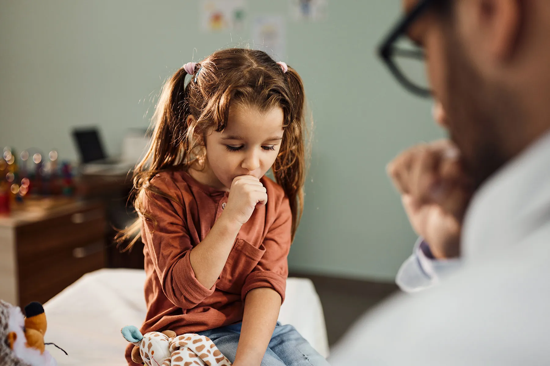 photo of girl coughing during a medical exam