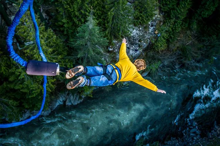 photo of man bungee jumping 