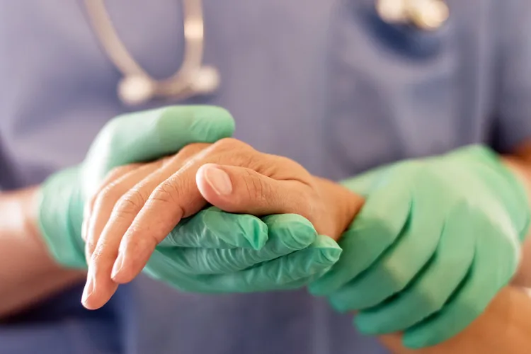 photo of surgeon holding patient's hand