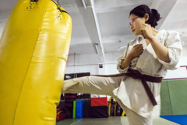 photo of woman practicing karate kick