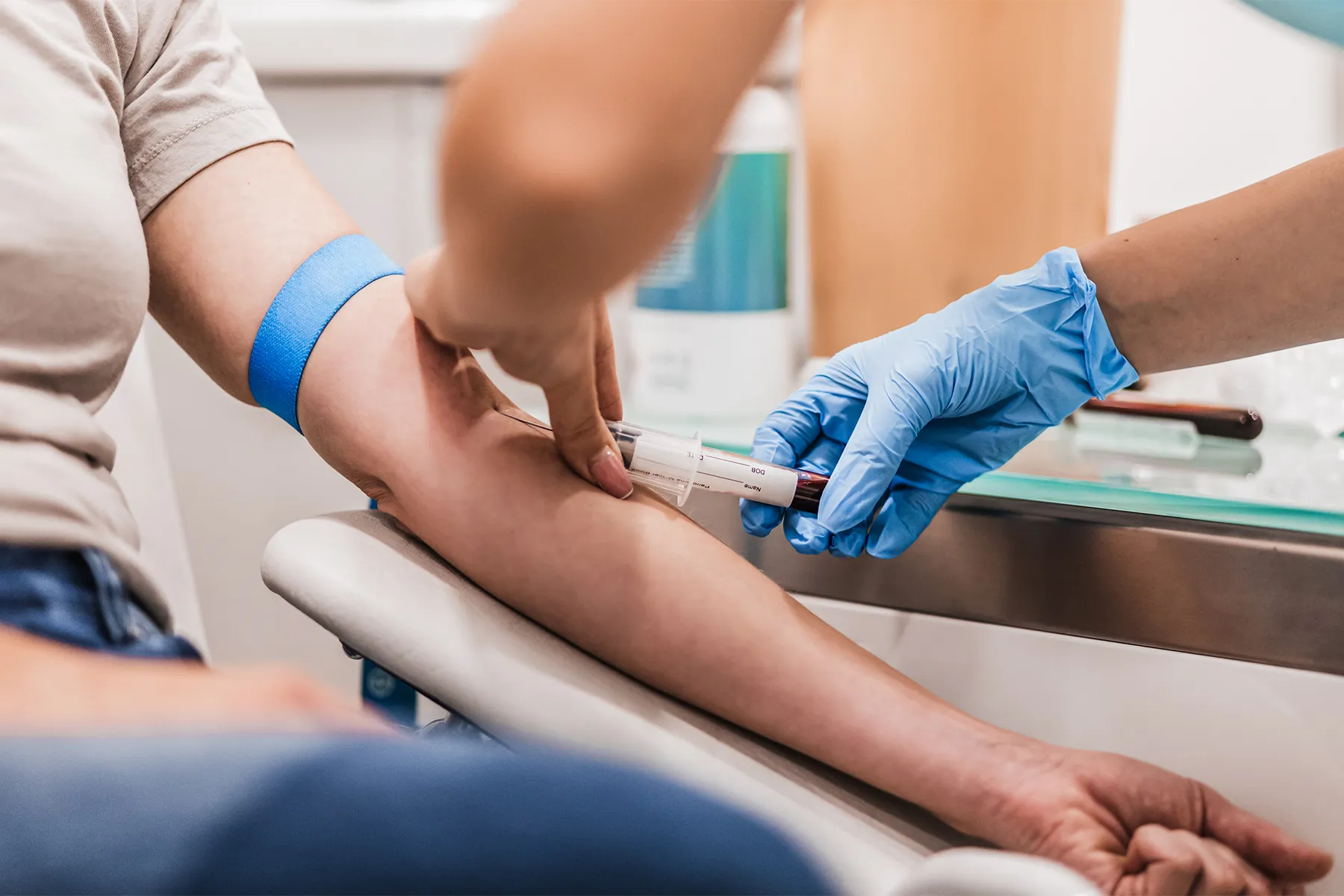 photo of Doctor Taking Blood Sample From Patient's Arm