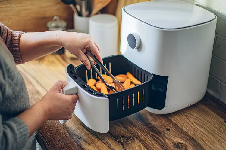 photo of Woman using air fryer