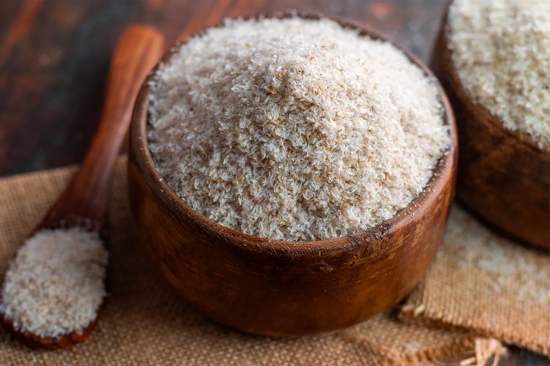 Psyllium husk in wooden bowls and spoon