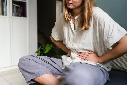 photo of woman with stomach ache