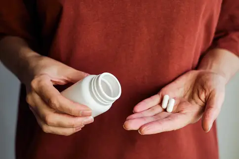 photo of woman pours pills