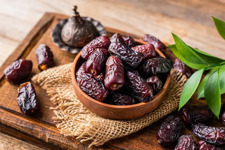 photo of medjool dates in a brown, clay bowl