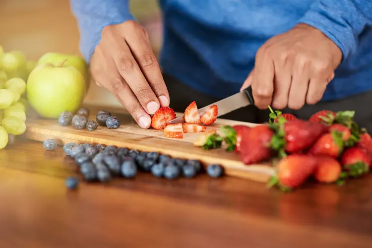 photo of man preparing a healthy and fruity snack
