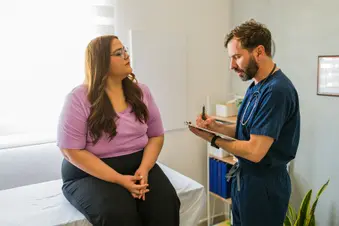 photo of woman talking to doctor