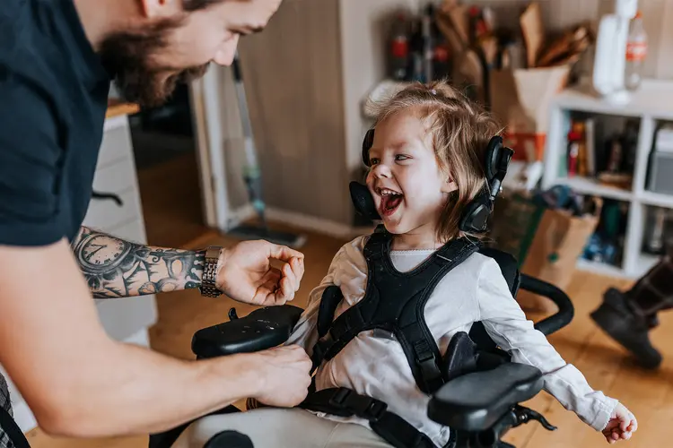 photo of  Father taking care of happy disabled child