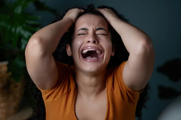 photo of a person with their hands on their head, experiencing emotional dysregulation