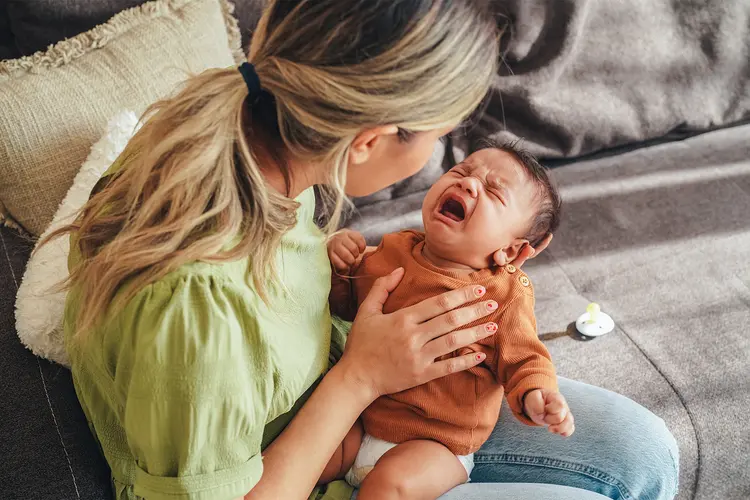 photo of mother comforting crying baby