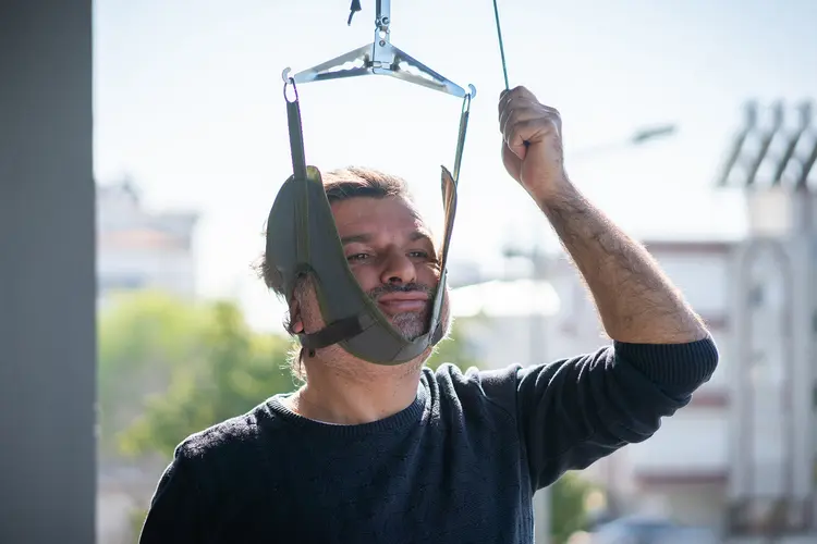 photo of man using neck traction device