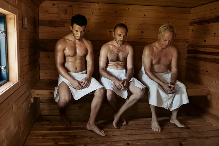 photo of Three men sitting in sauna