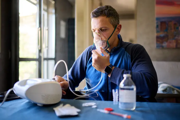 photo of man using nebulizer at home