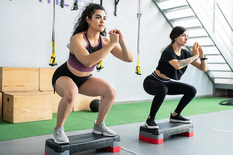 photo of Women Exercising On Step Platforms
