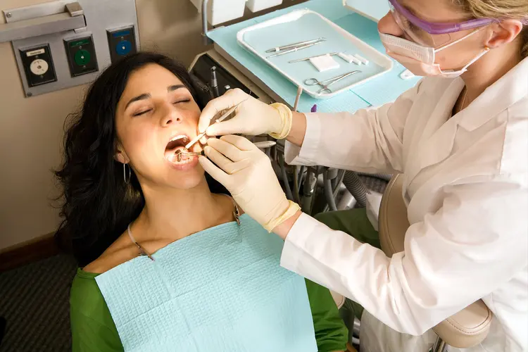 photo of dentist examining patient's teeth