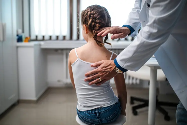 photo of Little girl being examined by orthopedist 