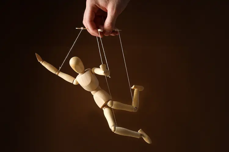 photo of hand holding mannequin